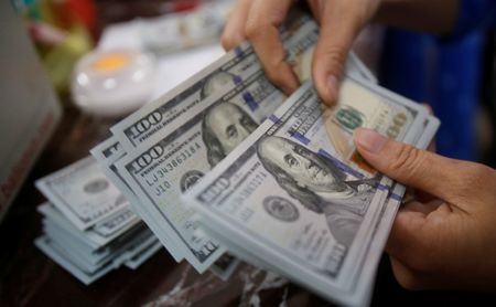 Dollar poised for weekly losses on improving risk sentiment
