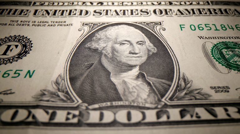 Dollar wobbles after Fed pushes back against rate hike speculation