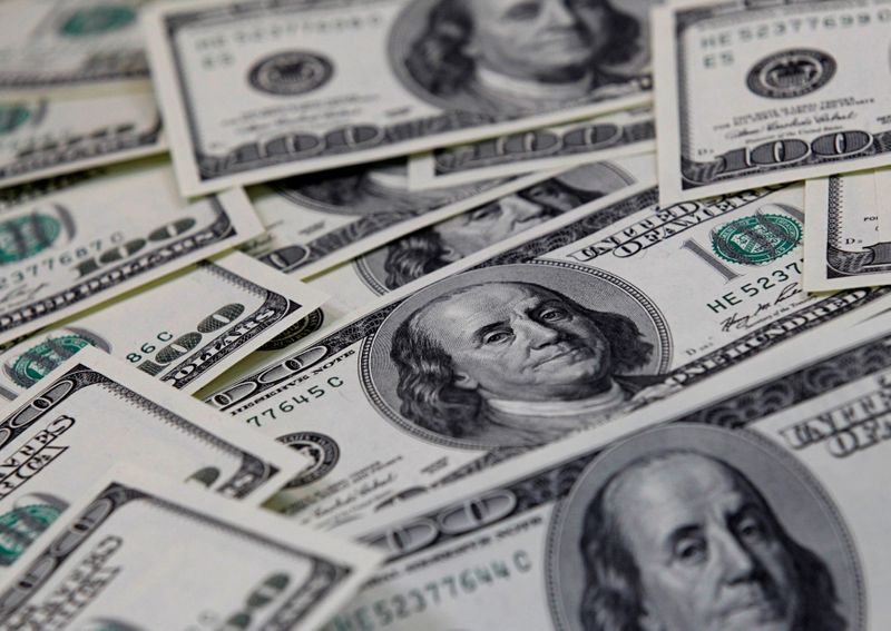 Dollar holds tight range as investors await U.S. inflation data